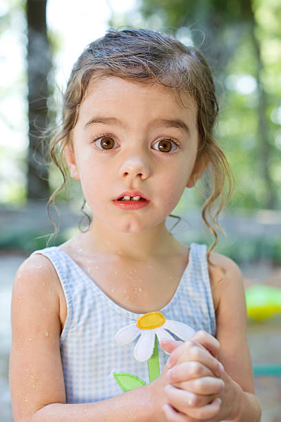 Little Girl in Bathing Suit looking surprised stock photo