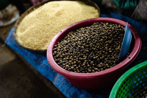 Blown coriander seeds displayed in a market in a red bowl