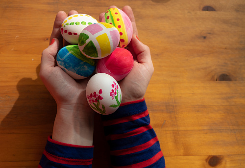 Woman hands holding Easter eggs