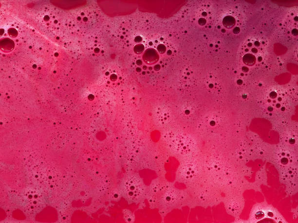 istock Magenta colorful bath foam with bubbles in the water. 1470717784