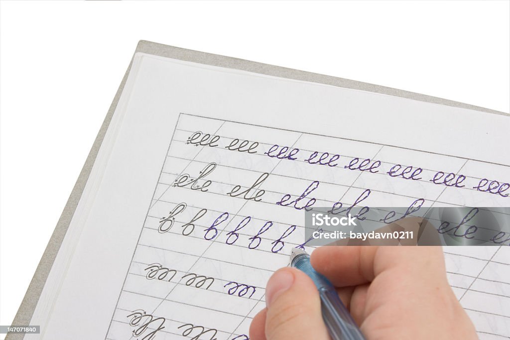 Child practicing cursive writing A little child hand learning to spelling Child Stock Photo