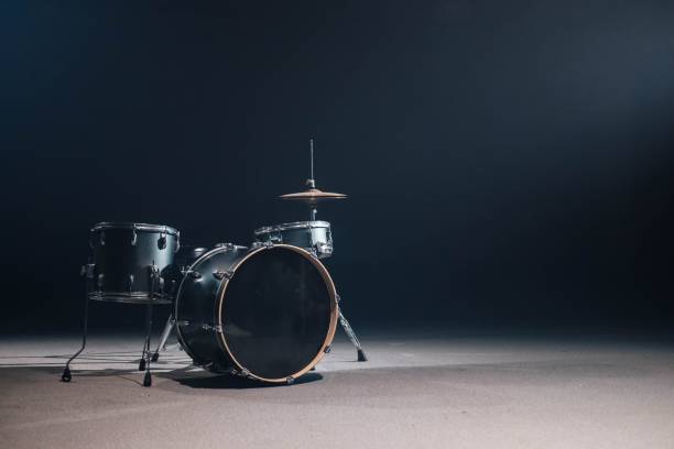 istock A drum set against a black background. A spotlight illuminates the drum from above. 1470719790