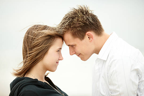 istock two young lovers kissing beach deep eye contact 147072302