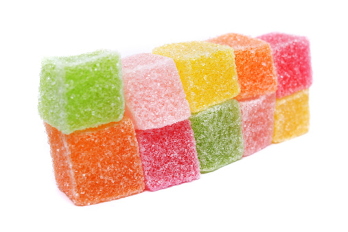 Soft sweets stacked together on white background.