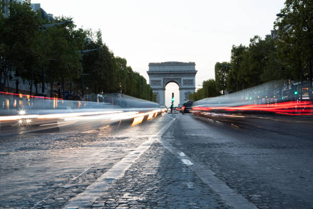 Blurred motion traffic at dusk with the Arc de Triomphe in the distance