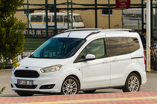 Side, Turkey -January 21, 2023:   white Ford Tourneo Courier   is parked  on the street on a warm summer day