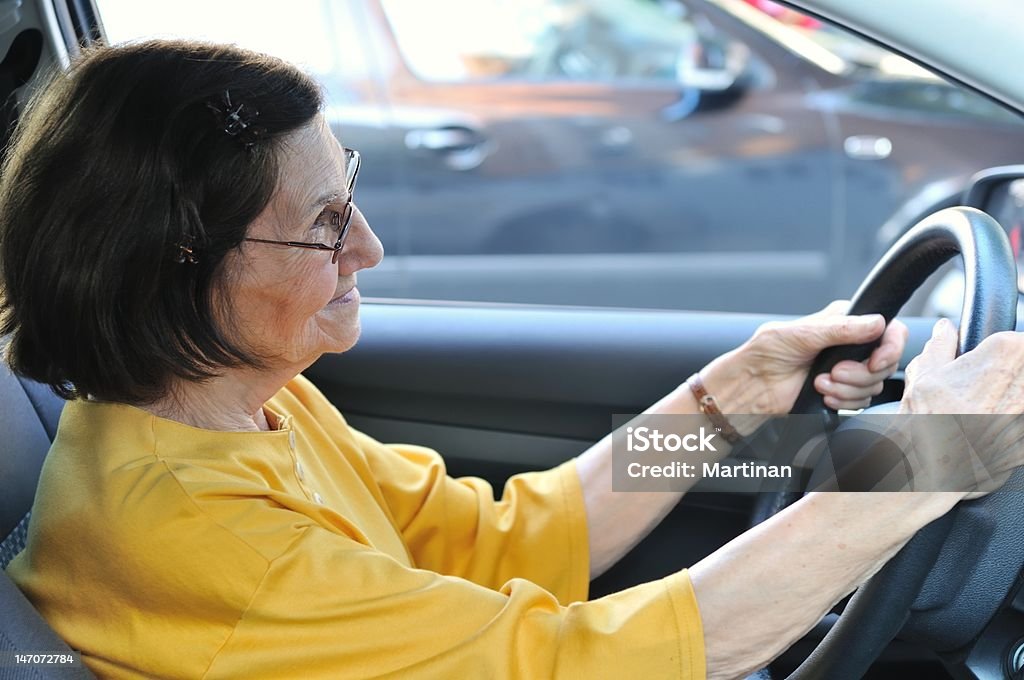 Senior woman driving car Active senior woman - grandmother driving car, detail Grandmother Stock Photo