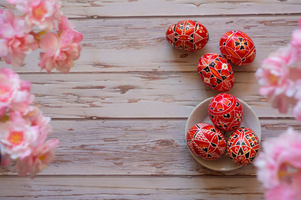 istock hand painted Sorbian Easter eggs on wooden table with cherry blossoms 1470728509