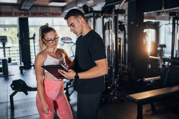 istock Young fit woman with trainer 1470729748