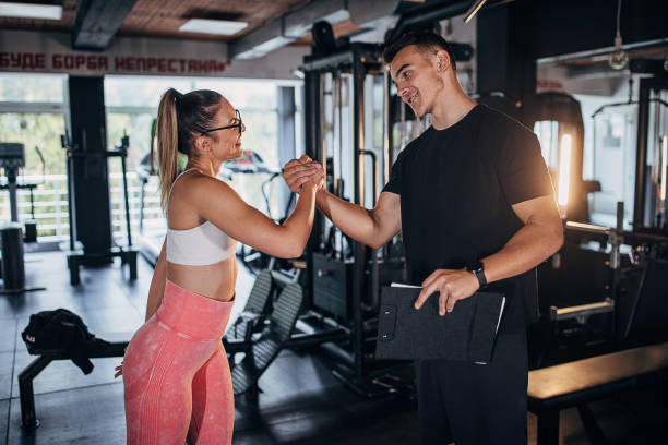 istock Young fit woman with trainer 1470729817