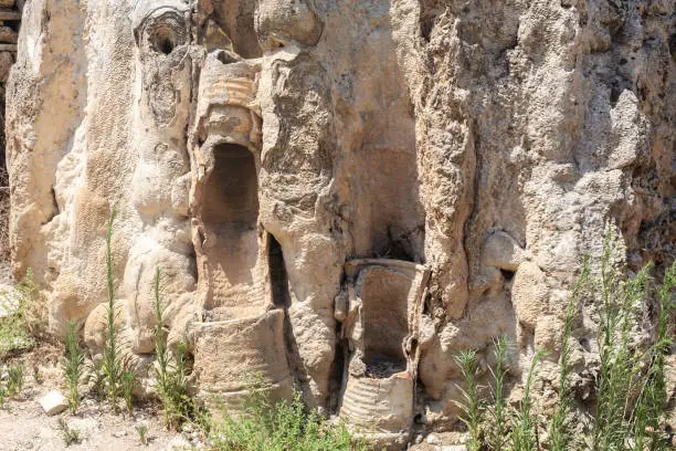 Photo of Roman pipe with sediments embedded in the rock. Ancient water supply system. Perge, ruined city in Ancient Anatolia. Antalya, Turkey (Turkiye)