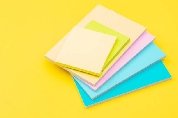 istock Stack of stickers and note papers on yellow background as back to school and back to work concept 1470731292