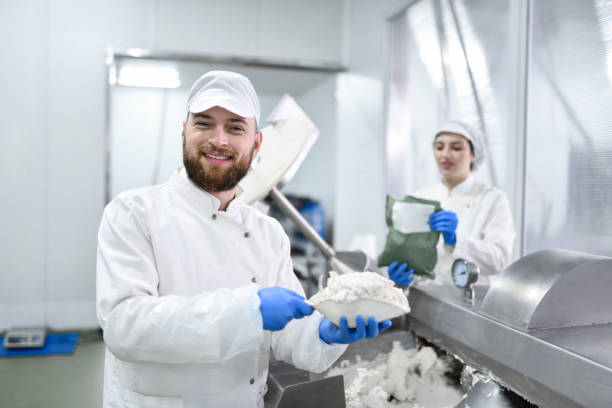 istock Bearded Male Worker Confidently Putting Cottage Cheese In Machine Used For Stuffed Pepper Mixture 1470731721