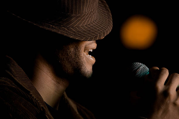 istock A bearded man singing with a hat over his eyes 147073257
