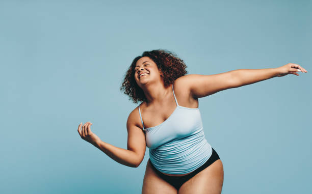 istock Athletic plus size woman dancing in a studio, expressing body positivity 1470732664