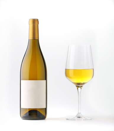 White wine bottle with blank label and a wine goblet