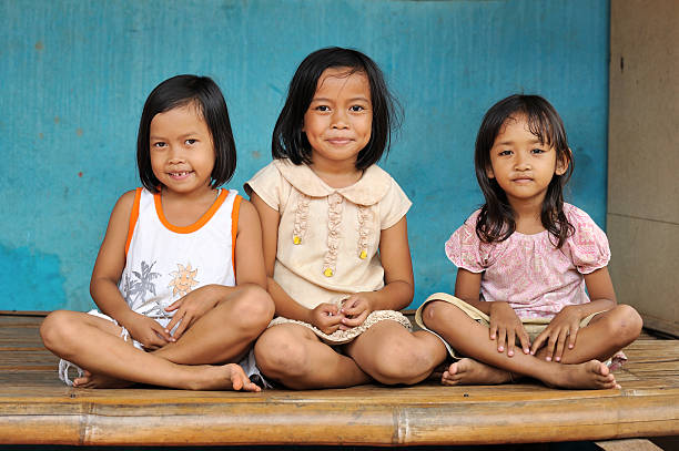 Three cute little girls living in poverty Group of Indonesian kids indonesian ethnicity stock pictures, royalty-free photos & images