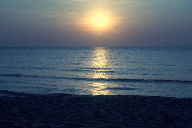 blue sea scape with sun set on blue sky background