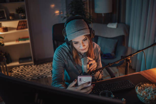 istock A young woman broadcasts or records a video podcast in a home studio from her room, using a microphone and headphones. 1470733895