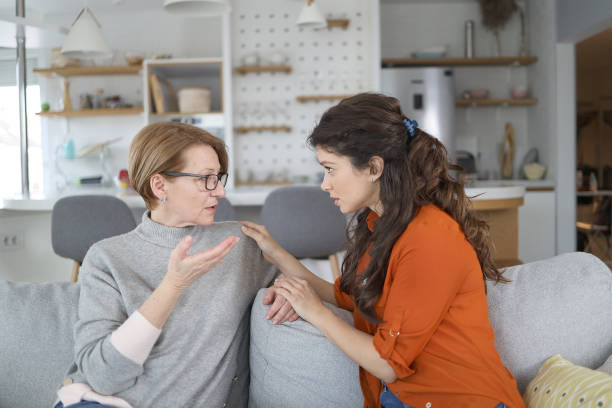 istock Senior woman bonding whit her daughter on the sofa 1470734384