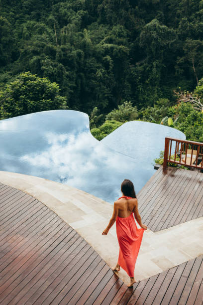 istock Young woman at luxury resort poolside 1470734438