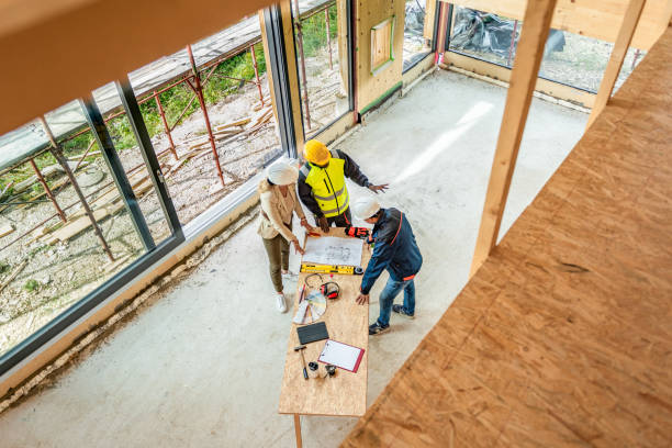 istock Building contractors discussing blueprint top view 1470735385