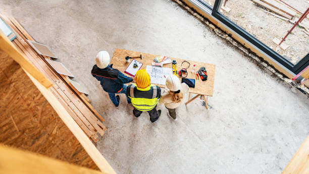 istock Building engineers discussing blueprint view from above 1470735388
