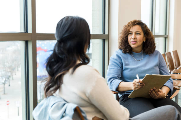 istock Serious female therapist listens as female client talks 1470735614