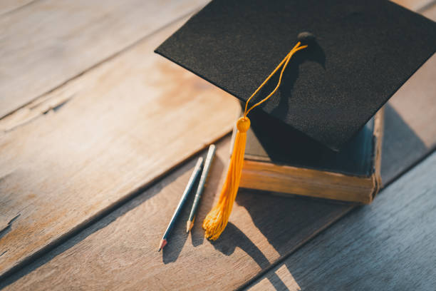 istock Graduation Cap university pace on wood table graduation concept 1470735693