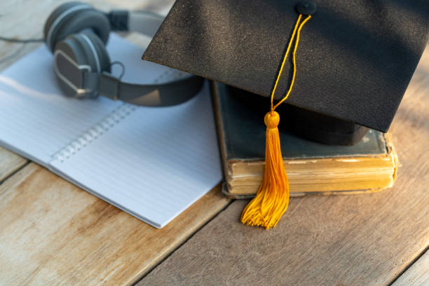 istock Graduation Cap university pace on wood table graduation concept 1470735778