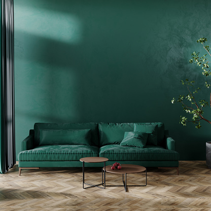 Green velvet sofa standing on parquet floor against green wall. 3d render image.