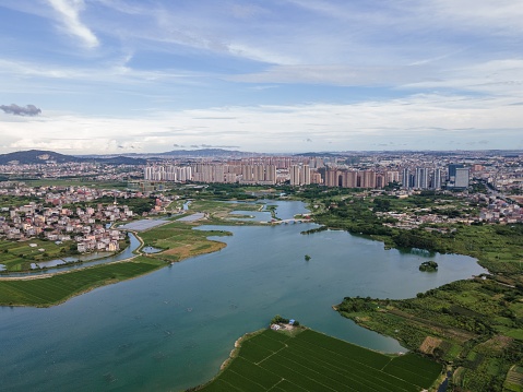 Aerial view of the wetland park and the city by the river