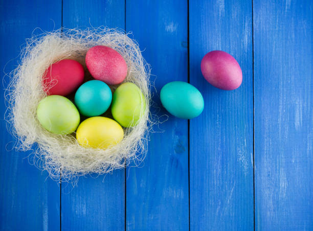 istock Colorful Easter eggs in the nest on blue wooden 1470737482