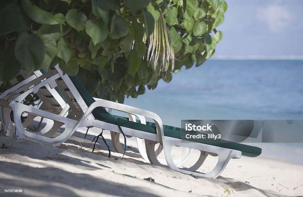 Lounge Chairs on Tropical Beach Lounge Chairs on Tropical Beach - Rarotonga, Cook Islands, Polynesia Abandoned Stock Photo