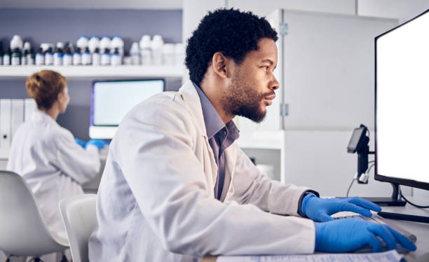 istock African scientist man, mock up and computer in research, reading or focus for goals in lab. Black man, science or laboratory with blank desktop pc for vision, healthcare or pharmaceutical mockup 1470739532
