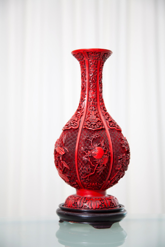 Chinese vase with curtain backdrop and reflective foreground