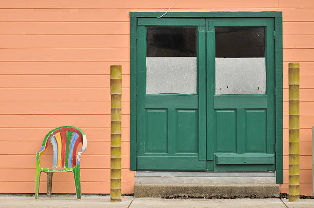 istock Two doors with a chair and poles 147074028