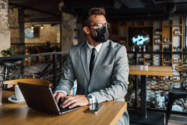 istock Businessman in a restaurant with protective face mask 1470740284