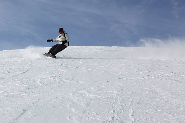 istock Passionate Guy Sliding On His Snowboard 147074057