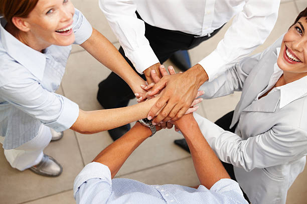 istock High angle view of business colleagues showing unity 147074108