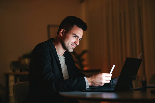 istock Smiling Businessman Working At Home Office At Night 1470741805