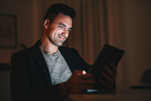 istock Happy Businessman Using A Digital Tablet At Home Office At Night 1470741869