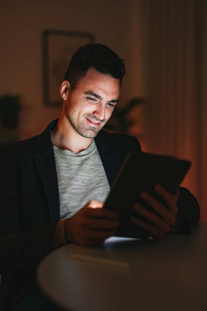 istock Smiling Businessman Using A Digital Tablet At Home Office At Night 1470741872