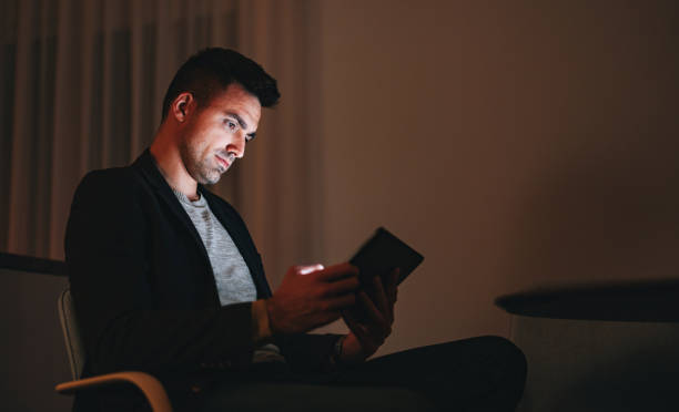 istock Serious Businessman Using A Digital Tablet At Home Office At Night 1470741901