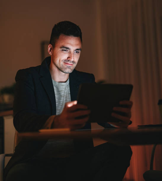istock Happy Businessman Using A Digital Tablet At Home Office At Night 1470741910