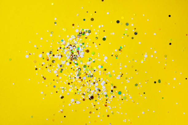 istock Flatlay of bright yellow background with colourful paper confetti with copyspace 1470743069