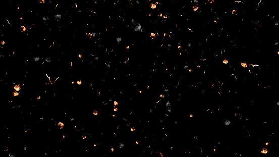 Fire burn ash or dust particles, flying and floating on air, overlay a black background in this still shot.