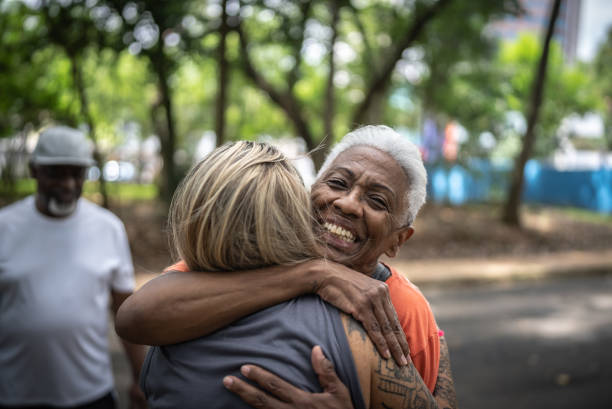 istock Friends greeting each other in the park 1470743720