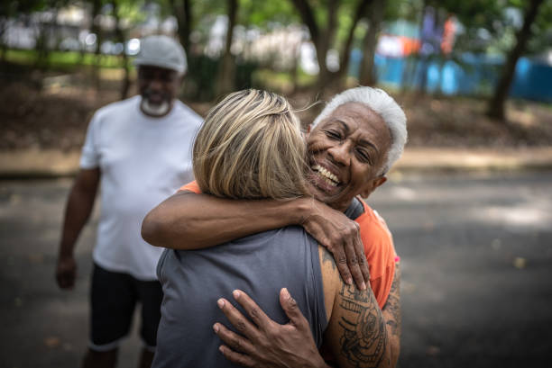 istock Friends greeting each other in the park 1470743722