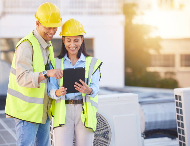 istock Engineer, man and woman with tablet for online research, schedule for building project and maintenance. Digital, people talking and construction worker with innovation, search internet and inspection 1470745372